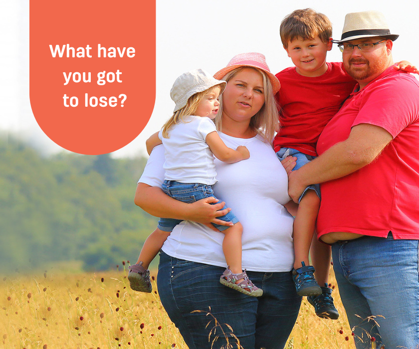 A couple standing in a field holding two young children, with the caption What have you got to lose?