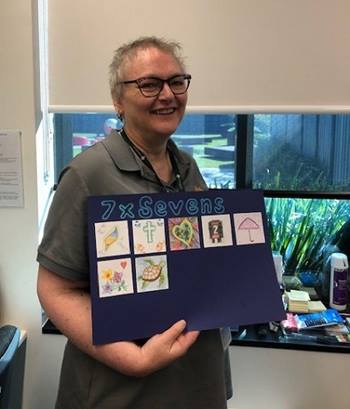 Oncology nurse showing an artwork made during art therapy
