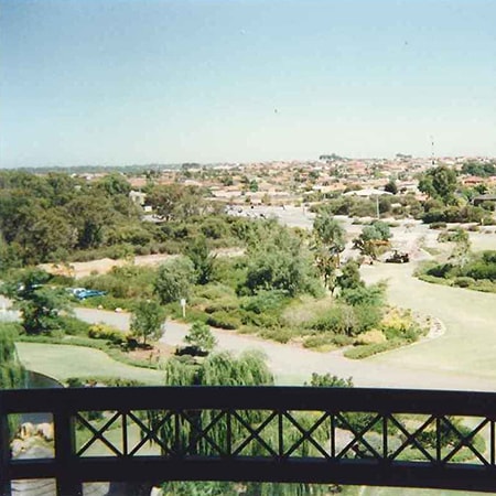 View of grass and trees in the Murdoch Hospital grounds from a balcony on the main ward block