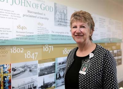 Ann Maree Mugavin standing in front of the hospital timeline