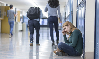 Young woman in school corridor